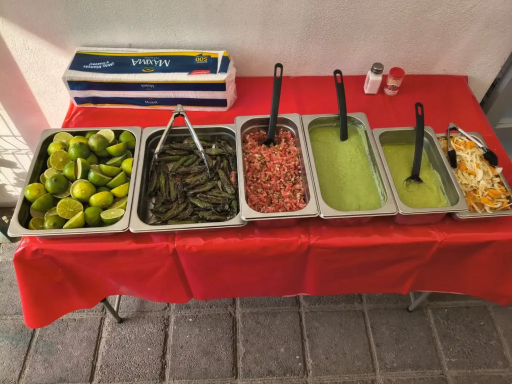 Barra de salsas y guarniciones de una taquiza de Santo Cazo